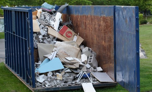 Front of a commercial waste collection vehicle parked at a business site